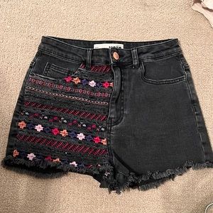 Black with a pattern on one side shorts.